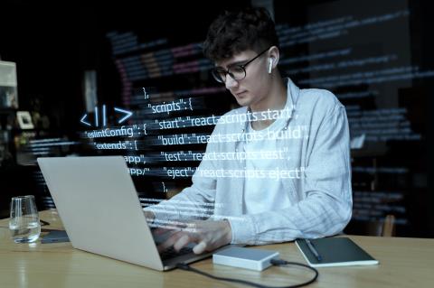programming-background-with-person-working-with-codes-computer