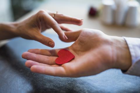 man-giving-red-ornament-heart-woman